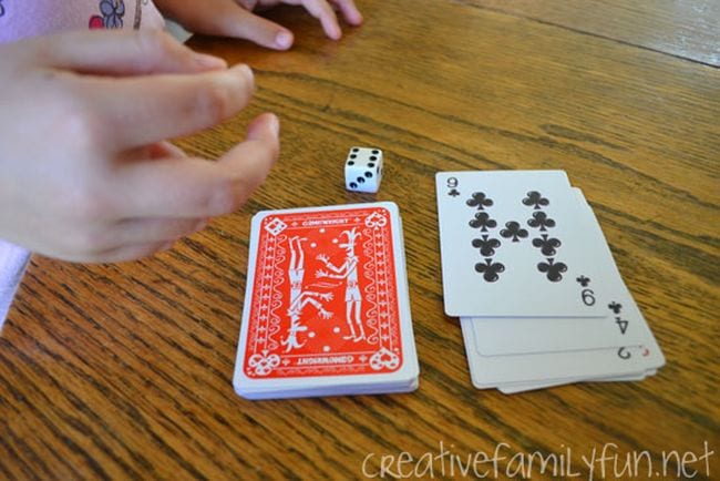 Student with a deck of cards and die