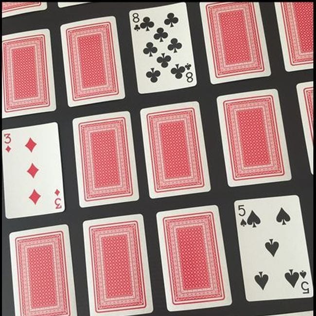 Playing cards laid out face down with three cards turned face up