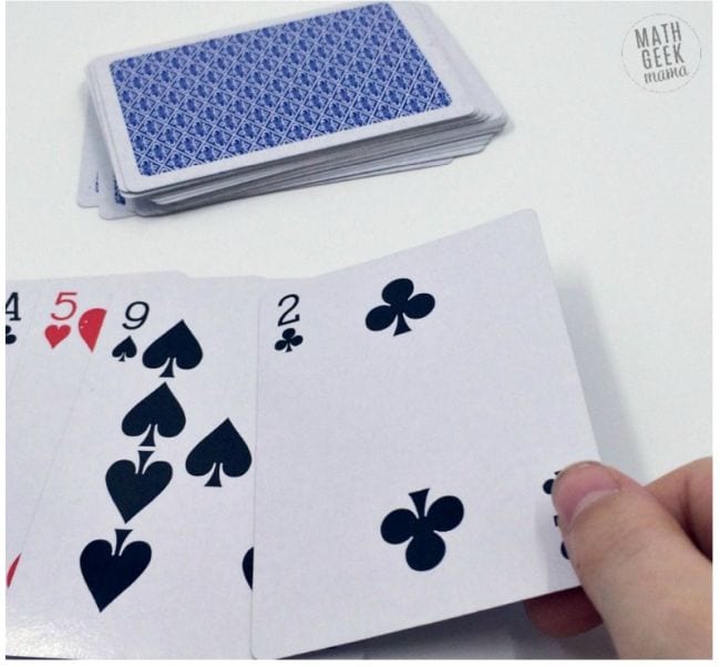 Student laying out playing cards to represent the digits of pi