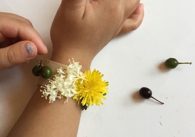 Hand with flower bracelet wrapped around it
