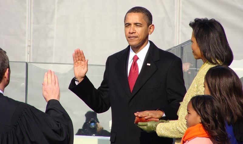 Barack Obama being sworn in as President of the United States of America, standing next to his wife Michele
