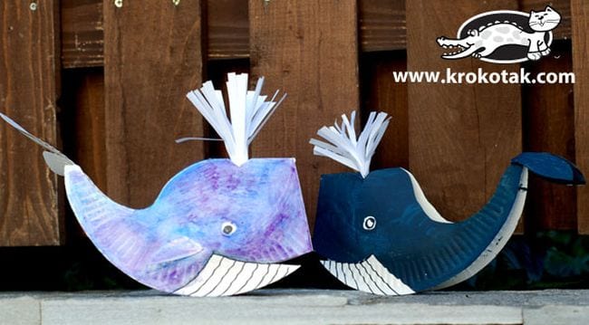 Two whales are shown that have been made from paper plates.