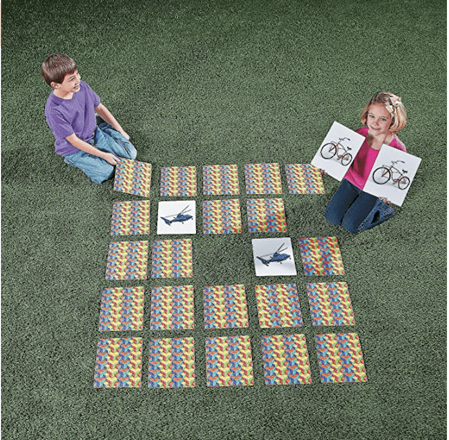 A boy and girl playing an outdoor memory game