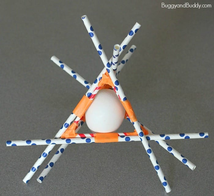 Egg surrounded by paper straws taped into place