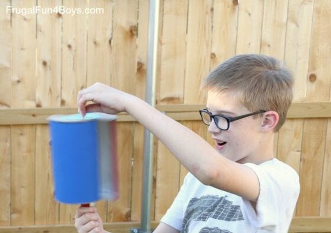 Outdoor science activities like this one show a student holding a homemade wind turbine 