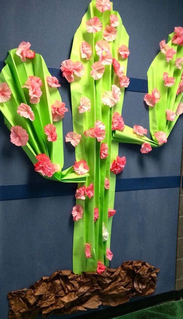 Paper cactus display adorned with pink decorative flowers