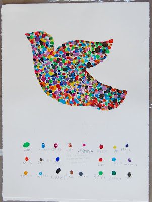 A colorful dove painting made from student fingerprints