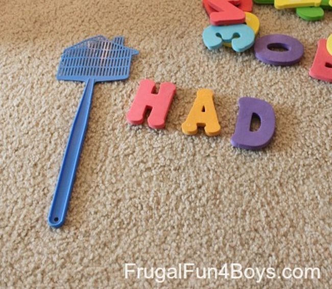 Alphabet magnets and a flyswatter laid out on a carpet (Phonics Activities)