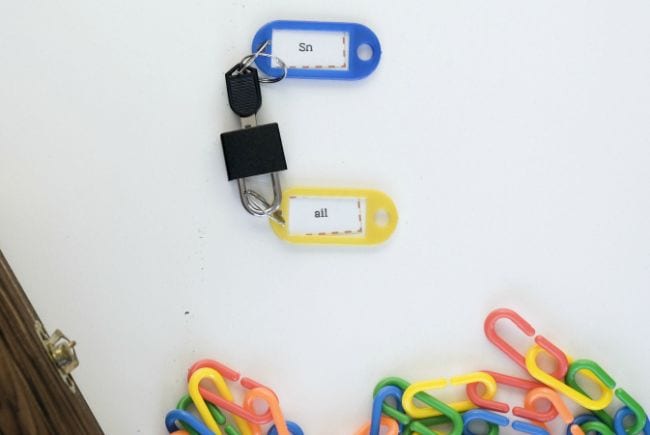 Simple lock and key, each with a plastic tag labeled with letter blends