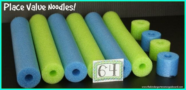 Blue and green pool noodles cut into long and short pieces, with card saying 64 (Place Value Activities)