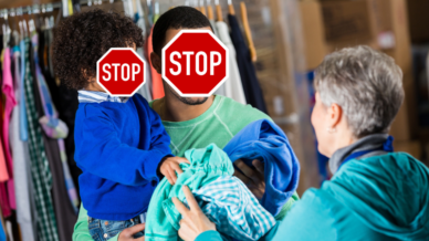 A stock photo of a student and dad being handed a donated coat at a coat drive