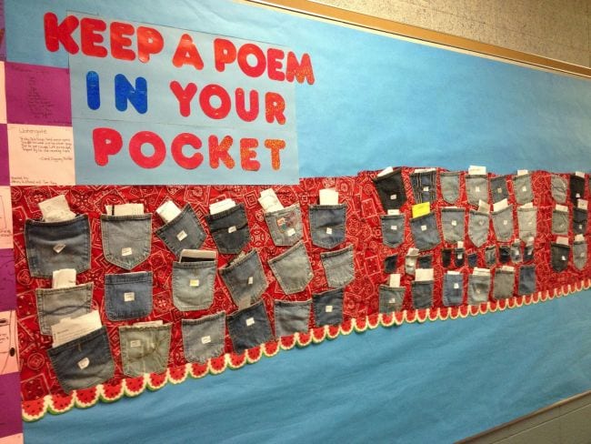 Keep a Poem in Your Pocket bulletin board with denim pockets full of paper slips (Poetry Games and Activities)