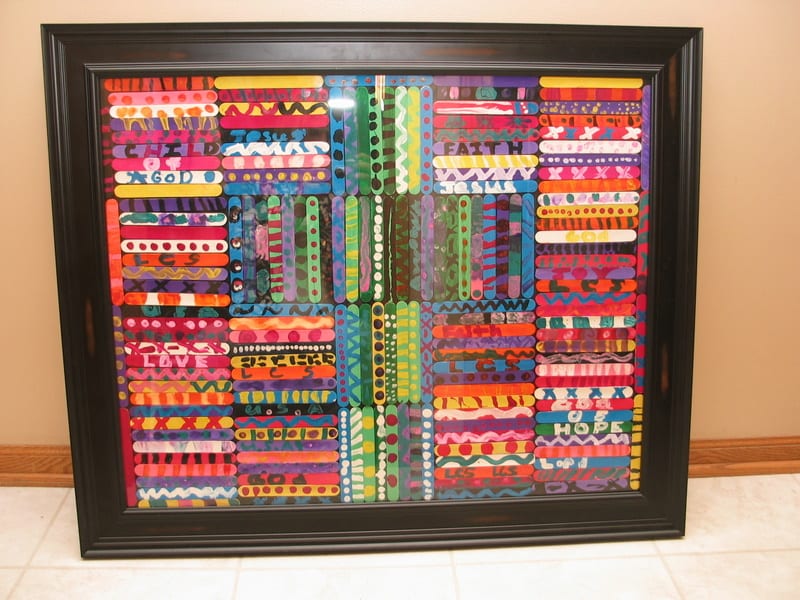 art auction ideas- colorful craft sticks are painted in bright colors and arranged in a geometric shape and framed