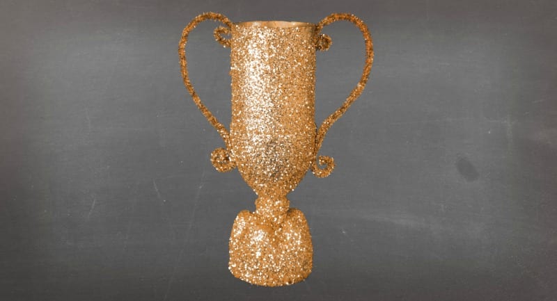 Adding glitter to the spray painted water bottle trophy