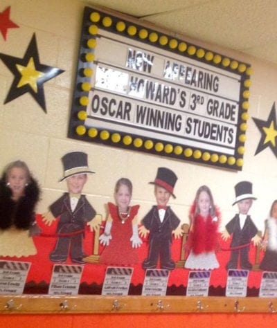 Hollywood themed bulletin board with students