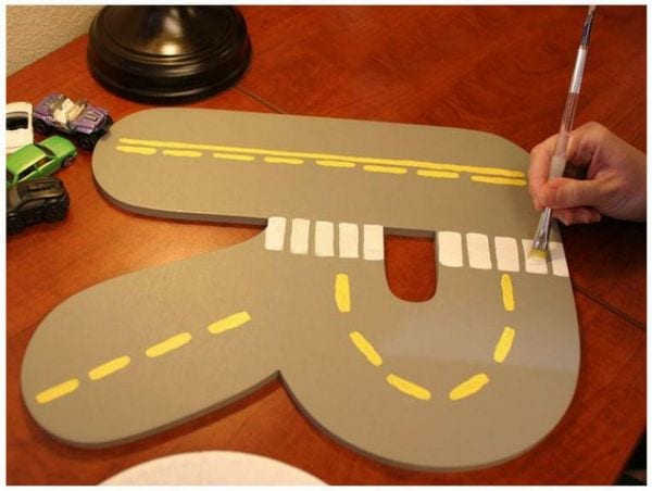 Large wood letter R painted to look like a road 