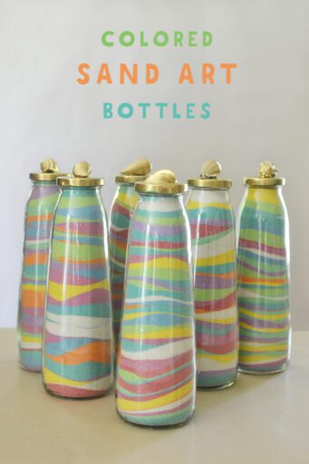 six slim glass bottles filled with layers of colored sand inside 