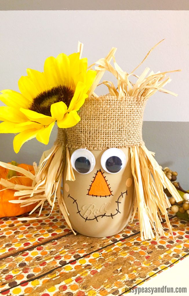 scarecrow face made from Mason jar, burlap, corn husks and silk sunflower