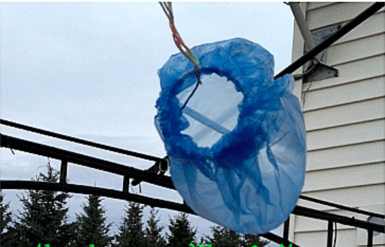 a homemade wind sock made from a blue plastic bag suspended by rope- weather activities