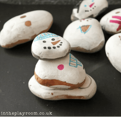 Snowmen winter crafts for the classroom made out of painted stones.