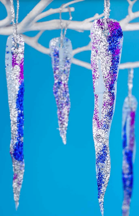 Glittery icicles winter crafts for the classroom hanging from tree.