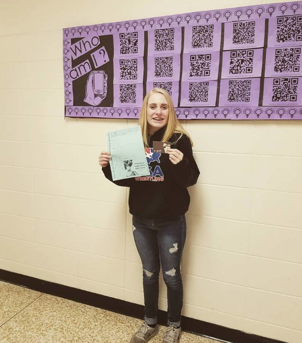 Student smiling with award