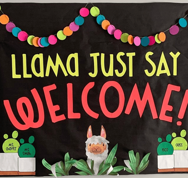 Bulletin board featuring a llama's head and potted plants. Text reads Llama Just Say Welcome!