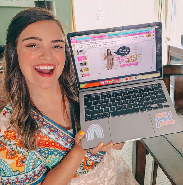 Teacher smiling with her computer