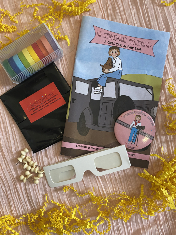 Girlscancrate photographer box with glasses, a book, and colored film