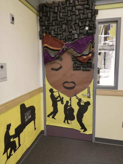 Door with drawing of Black woman and three musicians playing jazz instruments