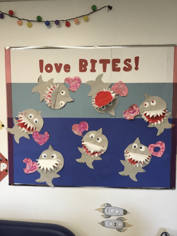 Board with cutouts of sharks and words love BITES!- Valentine's Day Bulletin Boards