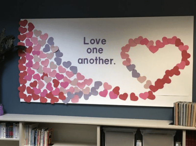 Bulletin board with words Love one another.