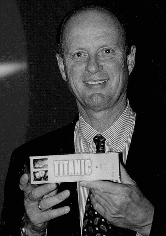 Robert Ballard smiling and holding a Titanic book