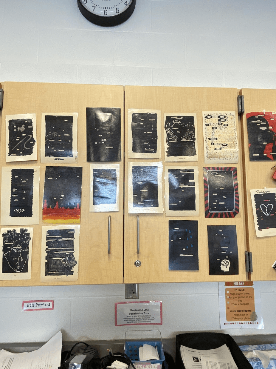 Many examples of blackout poetry hanging on cabinet in high school English classroom.