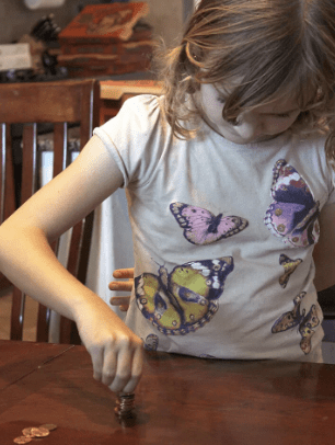 Child stacking pennies