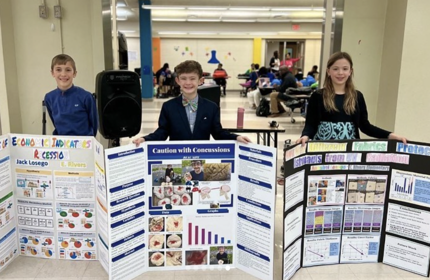 Science fair kids holding posters