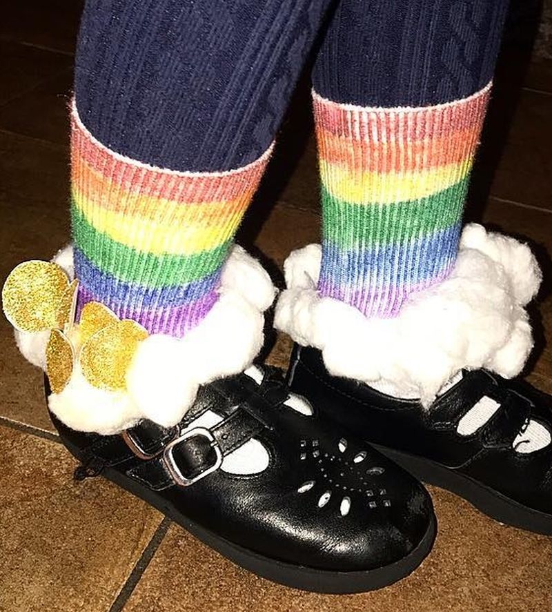 Rainbow colored socks with cotton ball clouds and paper gold coins
