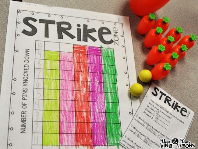 Toy bowling pins that look like carrots next to a graphing worksheet labeled Strike Zone