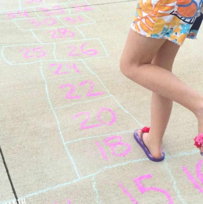 Second grade math student playing skip counting hopscotch games