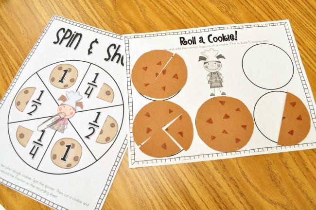Worksheets with cookie fractions and a spinner made from a paperclip, used to play second grade math games