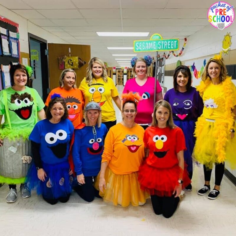 A large group of teachers are dressed as Sesame Street characters. 