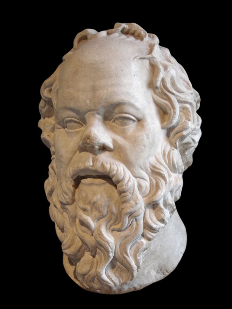 An old sculpture of a bearded head is shown.