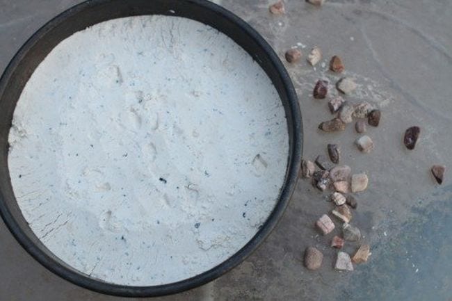 Space Activities for Kids- a cake pan with white sand inside and pebbles beside it