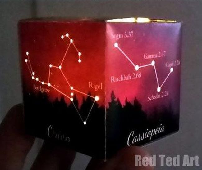 Space Activities for Kids- a paper cube with a different constellation printed on each face with holes poked through to allow light from a candle in the center to shine through