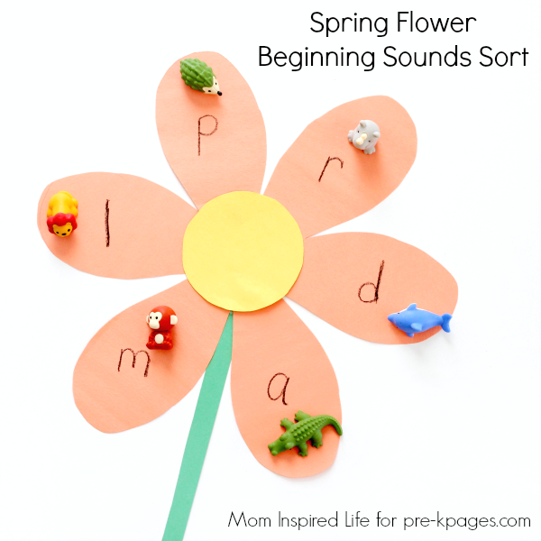 A construction paper flower with a letter written in each petal. On each letter is a mini plastic animal that starts with the same letter as an example of spring activities for preschoolers