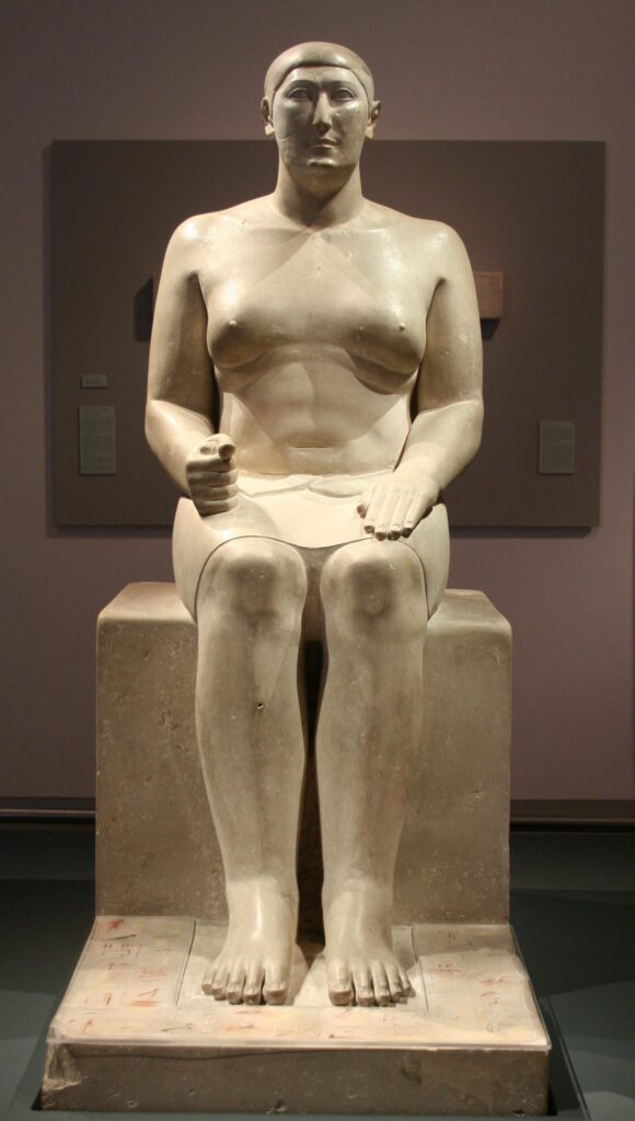 A statue of a seated man is shown.