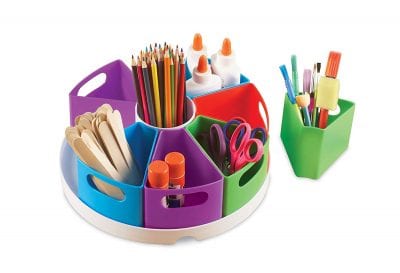 Tub with colored baskets filled with second grade classroom supplies