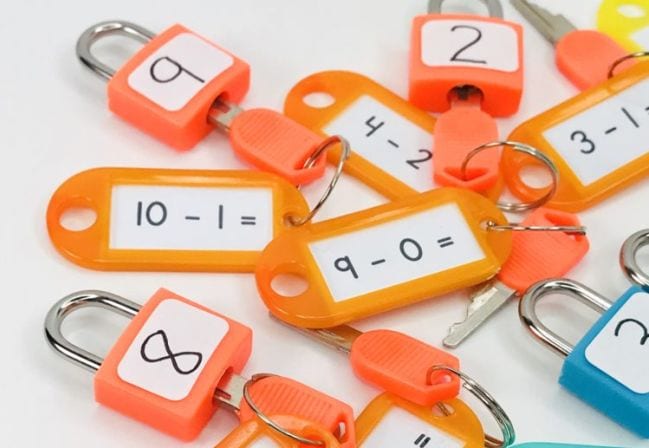 orange keys with subtraction problems written on the tag and orange locks with numbers written on them