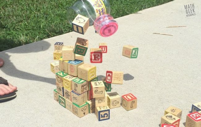 A block tower is knocked over by a yoyo on a string