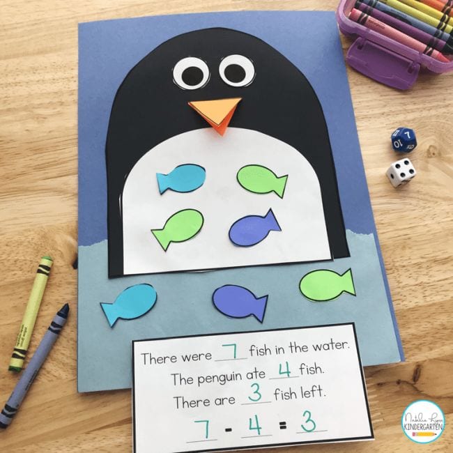 Construction paper goldfish are placed in a construction paper penguin's belly as an example of subtraction activities
